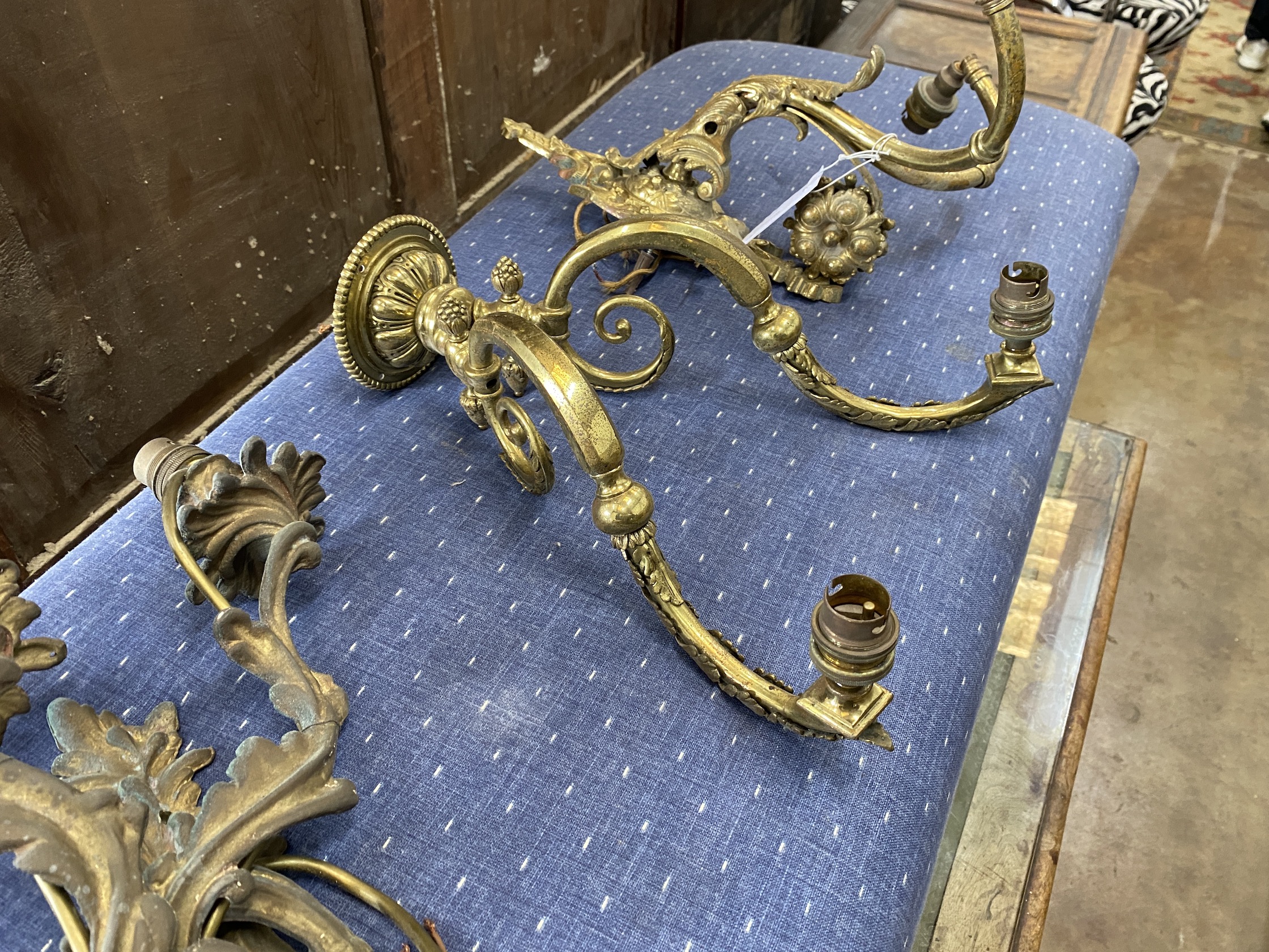 Three gilt metal wall lights, largest height 46cm